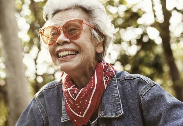 a cheerful female elderly in denim jacket