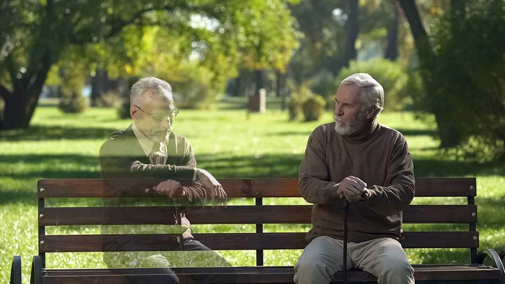 senior man looking at empty bench and remembering his friend loss memories
