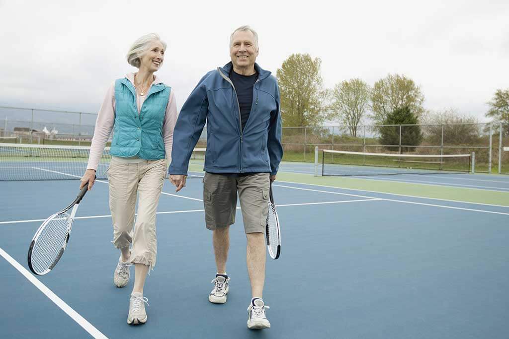 mature couple on the tennis court mature couple on the tennis court