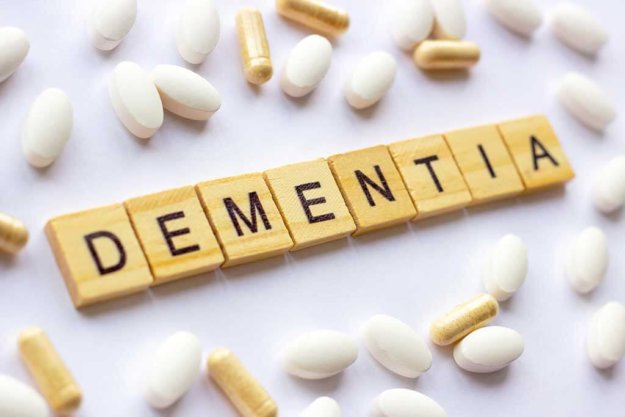 the medical phrase dementia on different pills and capsules background pharmacy theme