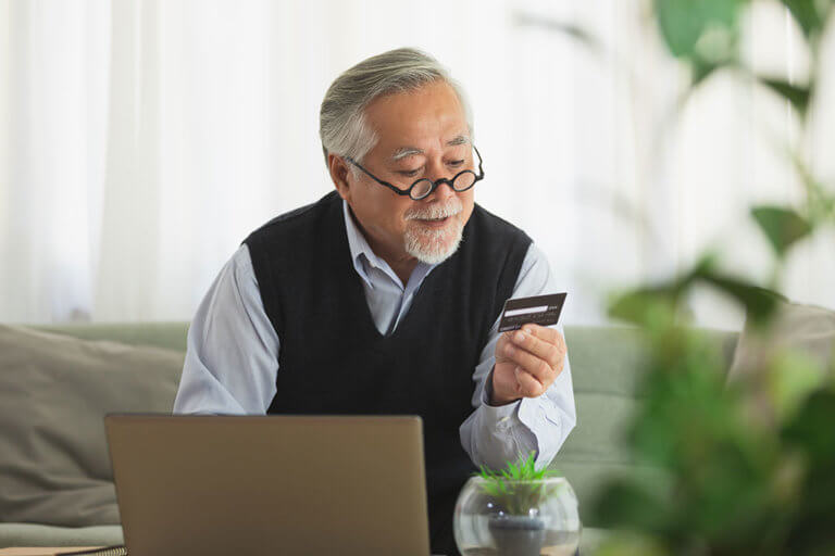 asian elderly man use cradit card shopping online
