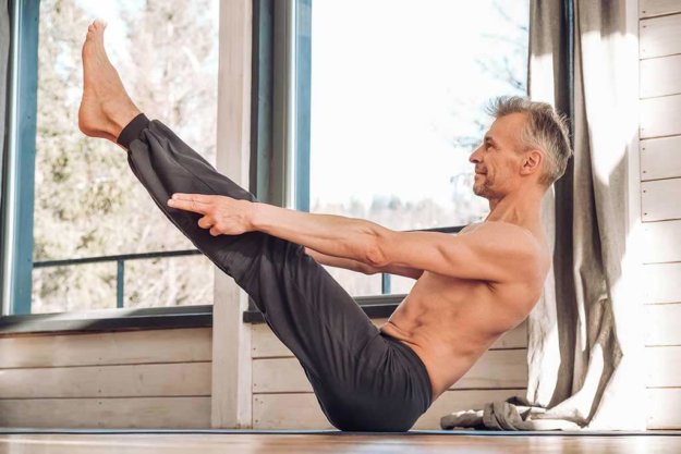 senior man with a naked torso practicing yoga senior man with a naked torso practicing yoga