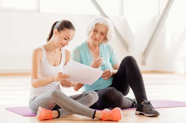 attractive positive woman holding a fitness program
