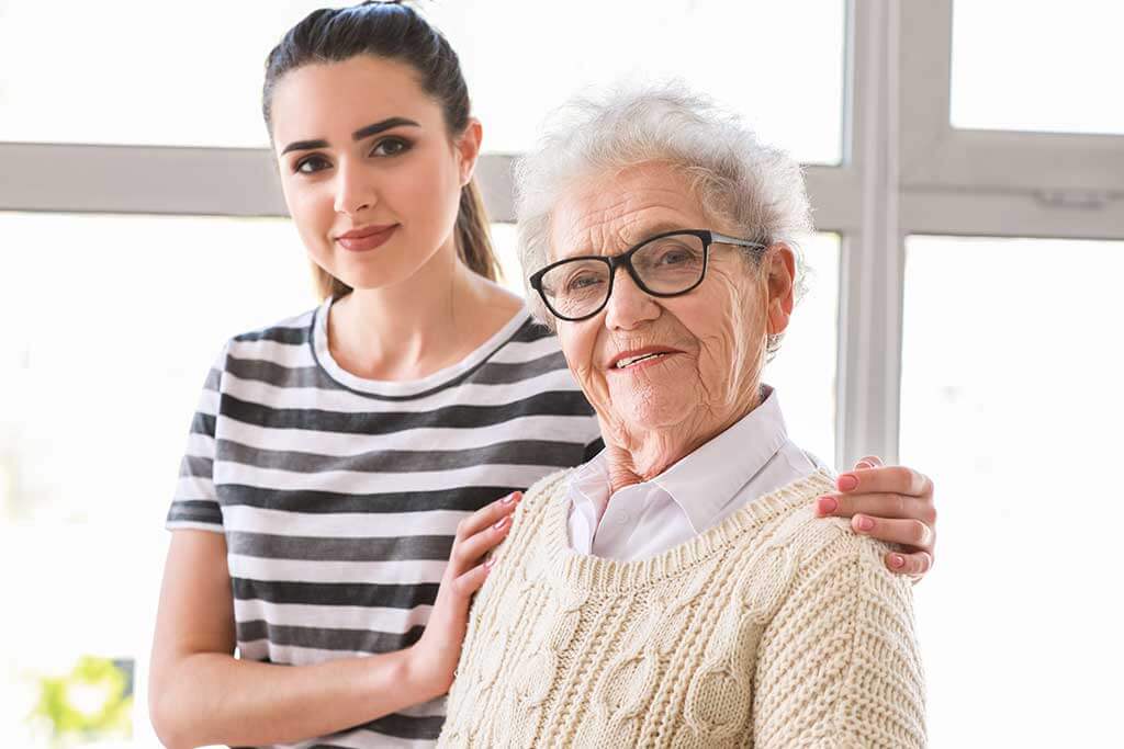 caregiver with senior woman in nursing home