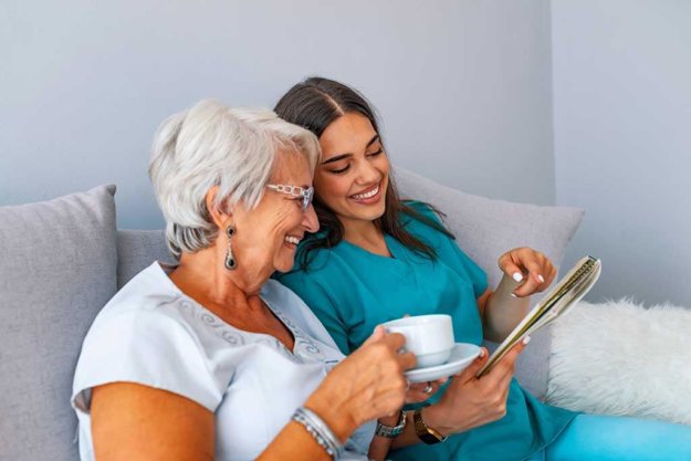 grandmother sitting on a couch in a sunny room