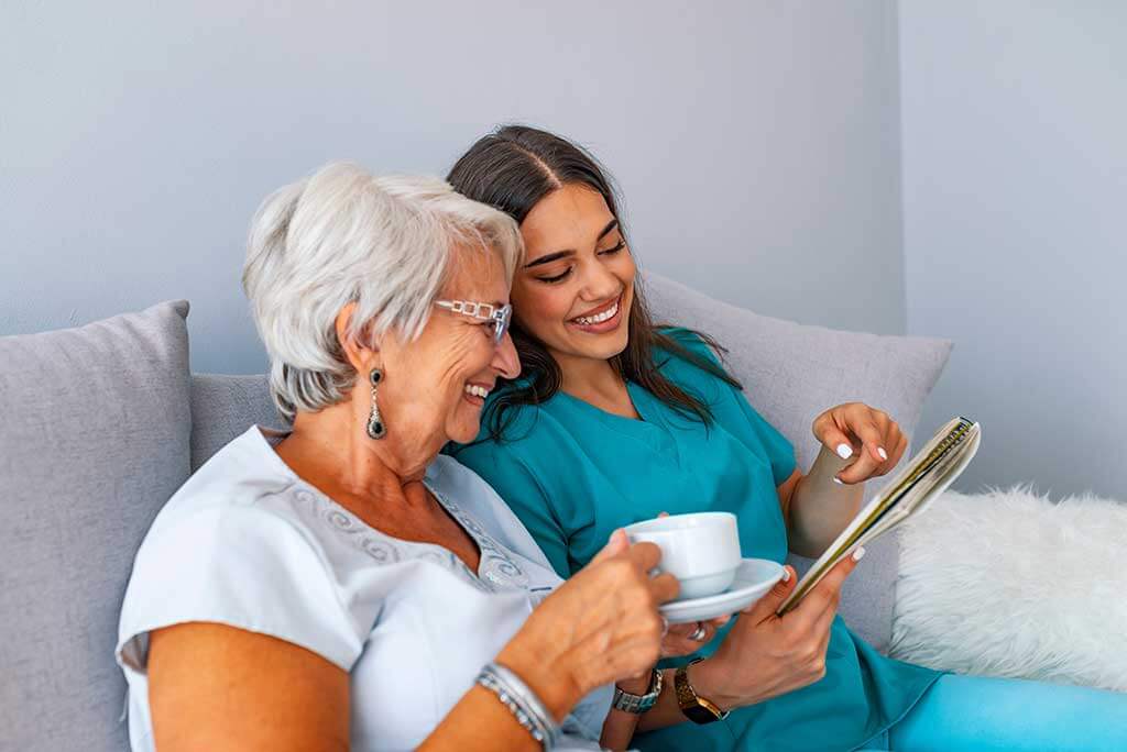 grandmother sitting on a couch in a sunny room