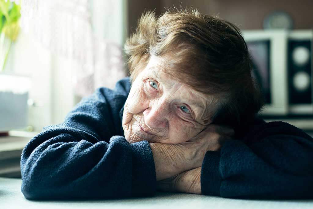old sad woman in her home depressed
