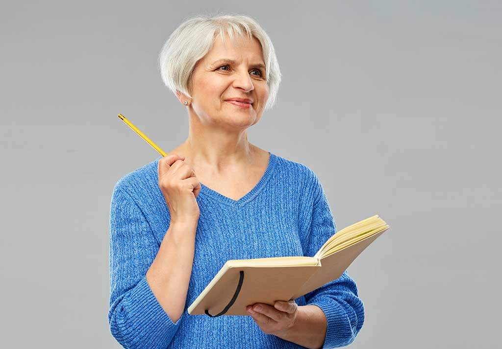 portrait of smiling senior woman in blue sweater