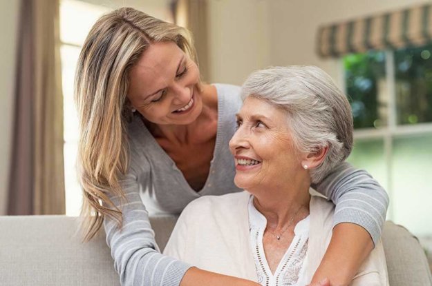 woman embracing senior mother woman embracing senior mother
