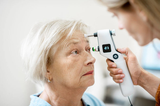 female ophthalmologist measuring the eye pressure female ophthalmologist measuring the eye pressure