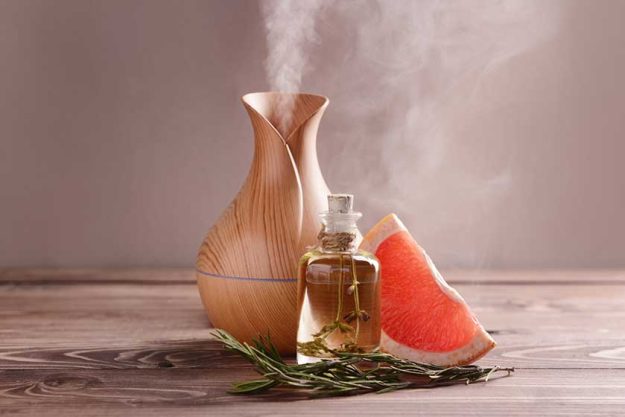 aroma oil diffuser rosemary and grapefruit on table aroma oil diffuser rosemary and grapefruit on table