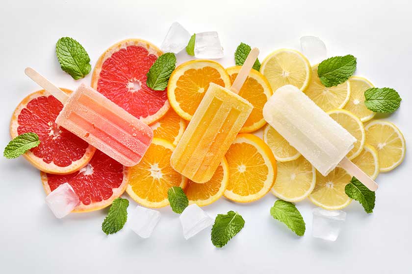 orange ice lolly ice cubes and slices of orange