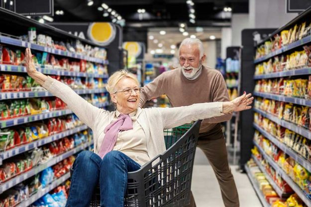 a senior couple having fun at supermarket a senior couple having fun at supermarket