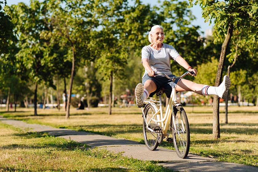 joyful senior woman riding a bicycle