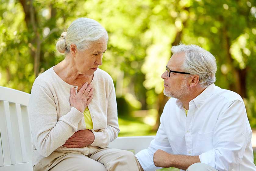 senior woman feeling sick at summer park