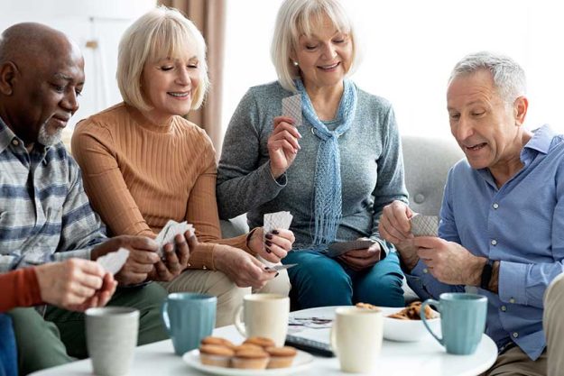 closeup of cheerful elderly people chilling together playing cards closeup of cheerful elderly people chilling together playing cards