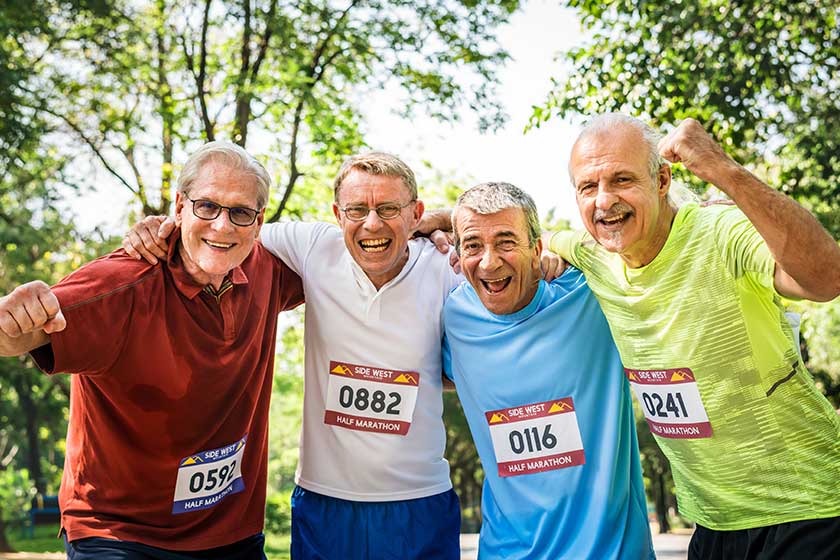 group of cheerful senior runners at the park group of cheerful senior runners at the park