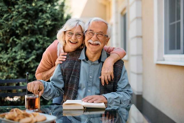 happy senior couple at independent living community looking at camera happy senior couple at independent living community looking at camera