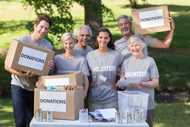 happy volunteer family holding donations boxes happy volunteer family holding donations boxes