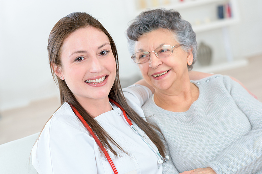 old lady smiling to a nurse