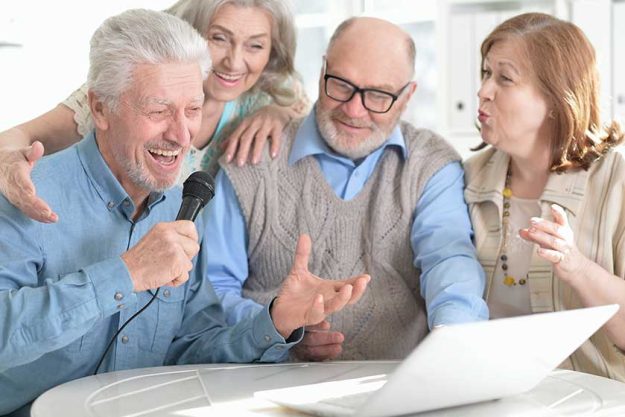 portrait of two senior couples reading newspaper portrait of two senior couples reading newspaper