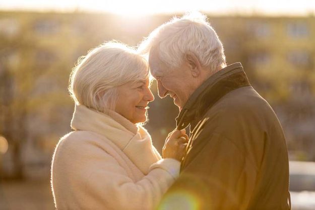 senior couple hugging outdoors in autumn