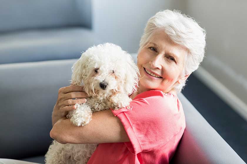 senior woman holding a dog