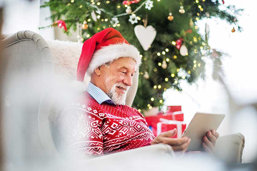 a portrait of senior man with tablet sitting on armchair at home a portrait of senior man with tablet sitting on armchair at home