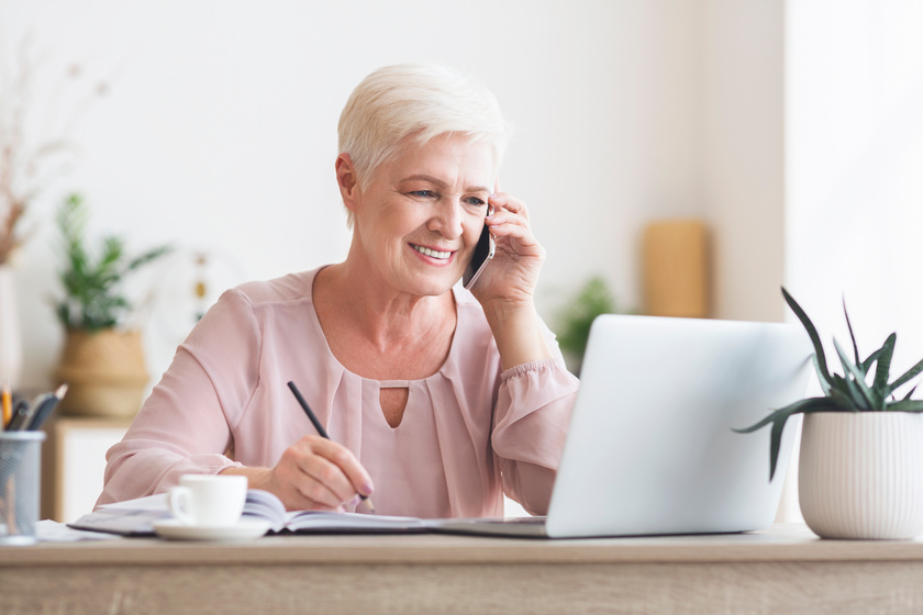 smiling elderly lady talking to business partners