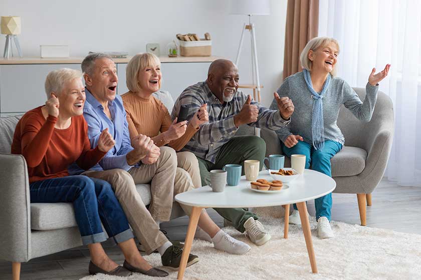 emotional senior people watching television in the living room