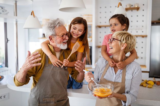 grandchildren having fun at home while playing with their grandparents