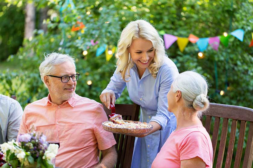 leisure holidays and people concept happy family having festive dinner