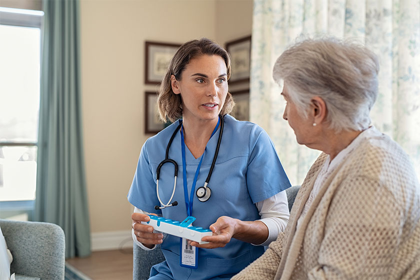 nurse explaining medicine dosage to senior woman