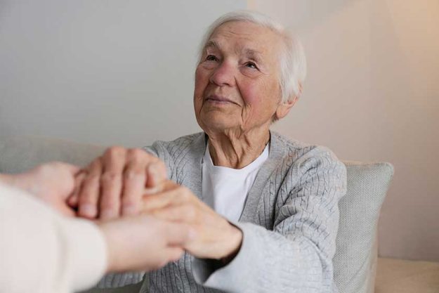 portrait of a mature female in elderly care facility getting help from hospital personnel nurse portrait of a mature female in elderly care facility getting help from hospital personnel nurse