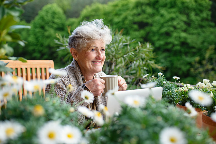 senior woman with laptop and coffee senior woman with laptop and coffee