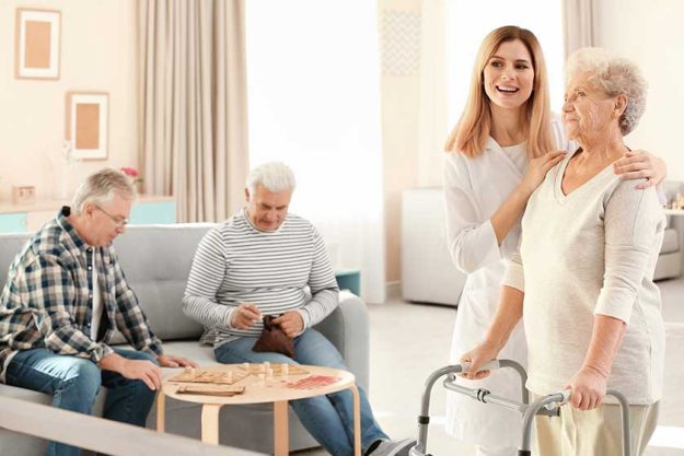 senior woman with walkers and nurse at care home