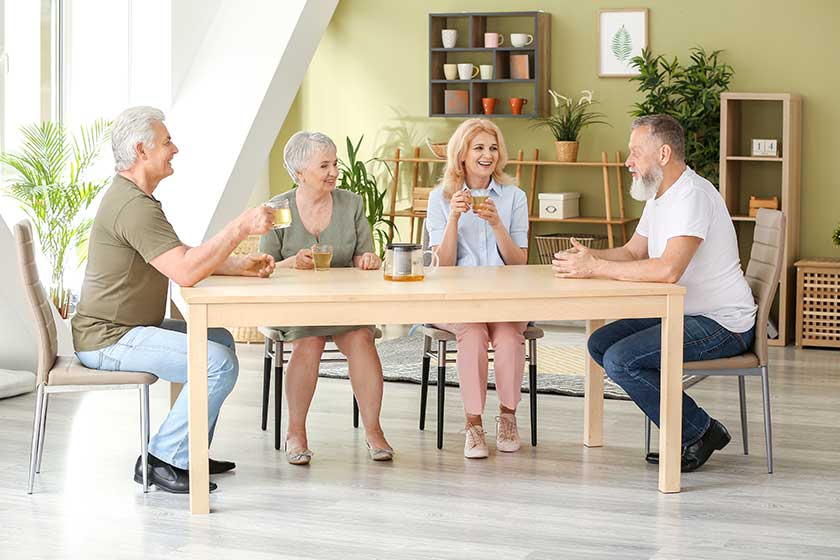 happy senior people spending time together in nursing home