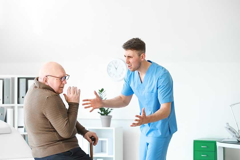 medical worker mistreating senior man in nursing home medical worker mistreating senior man in nursing home