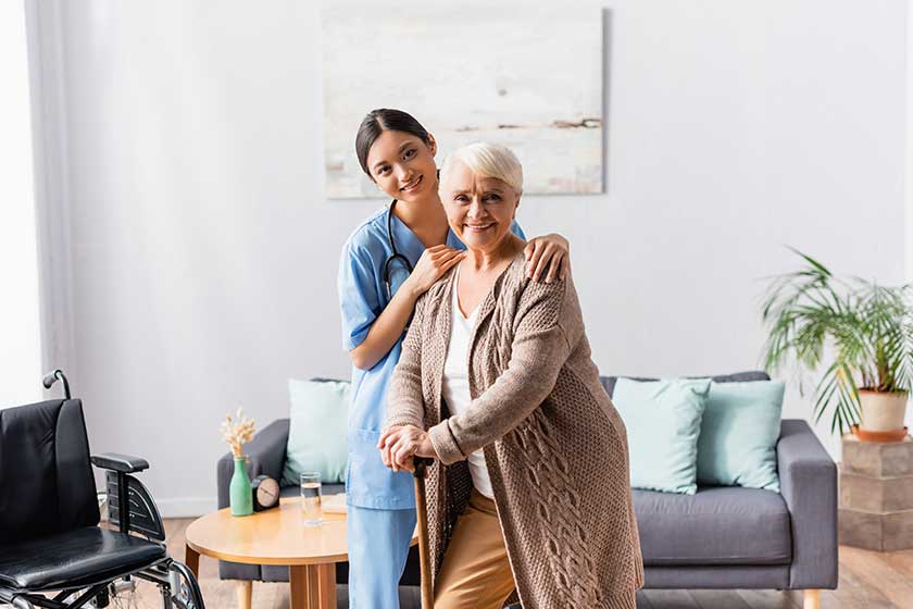 smiling asian nurse and elderly woman with walking smiling asian nurse and elderly woman with walking