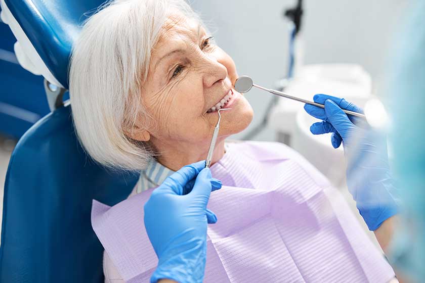 smiling pensioner showing teeth for dental inspection