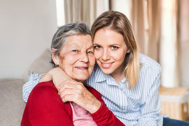 an elderly grandmother with an adult granddaughter