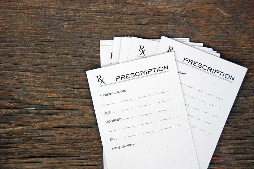 blank prescriptions over wooden table