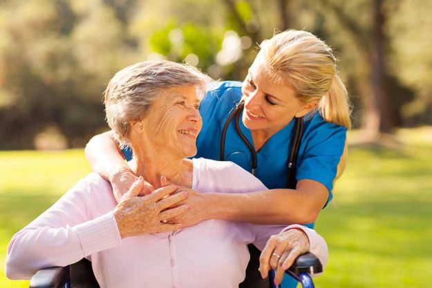 caring nurse with senior patient