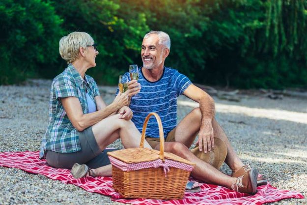 cute senior couple enjoying picnic