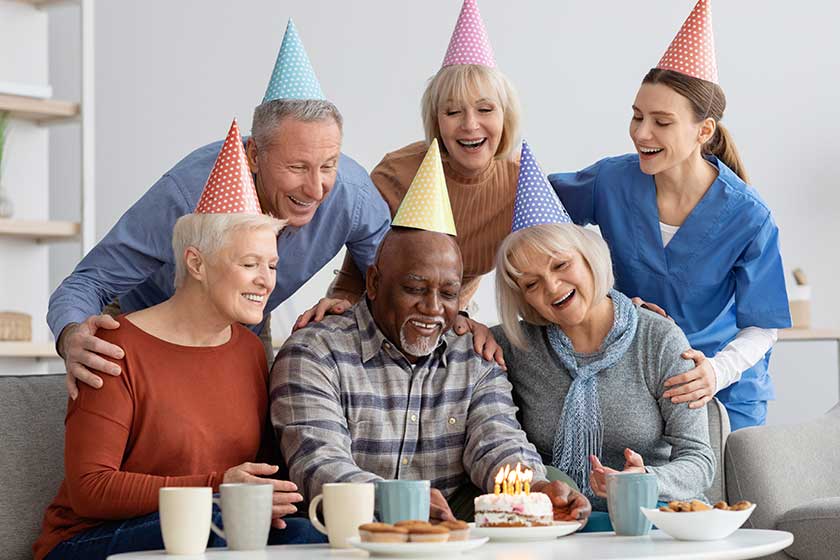 elderly black man having birthday party at nursing home