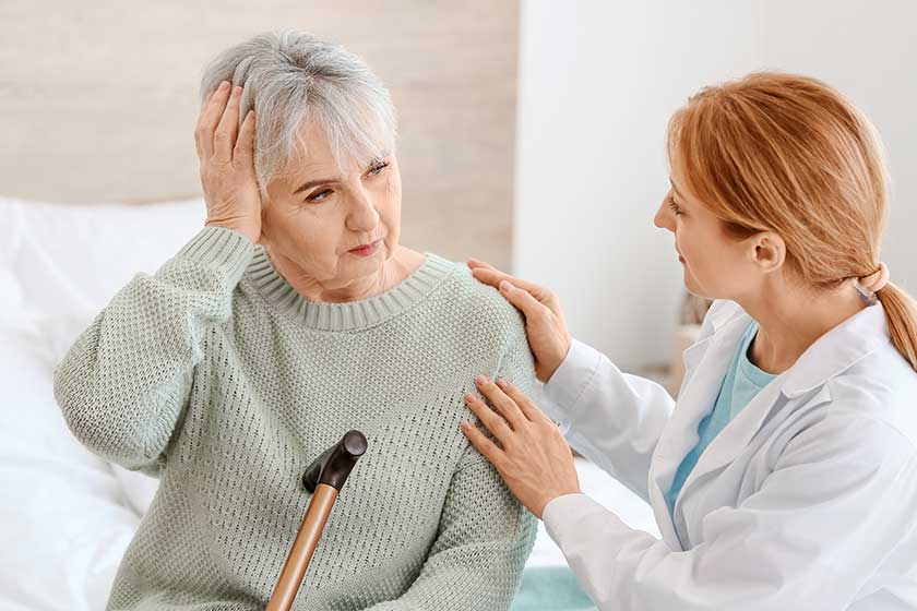 elderly woman suffering from mental disability with doctor at home elderly woman suffering from mental disability with doctor at home