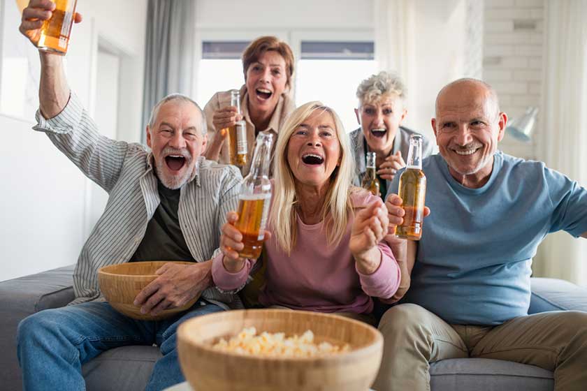 group of senior friends having party indoors