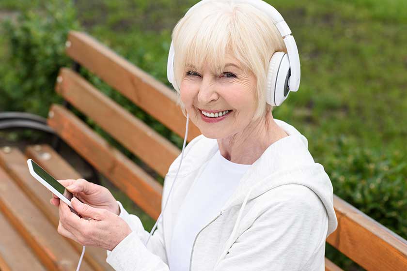 happy senior woman listening music