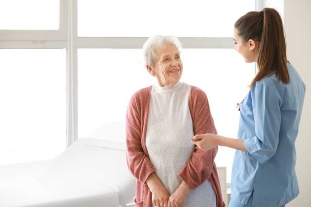 medical worker with senior woman in nursing home medical worker with senior woman in nursing home