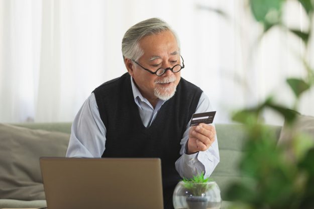 modern elderly man grandfather shopping online